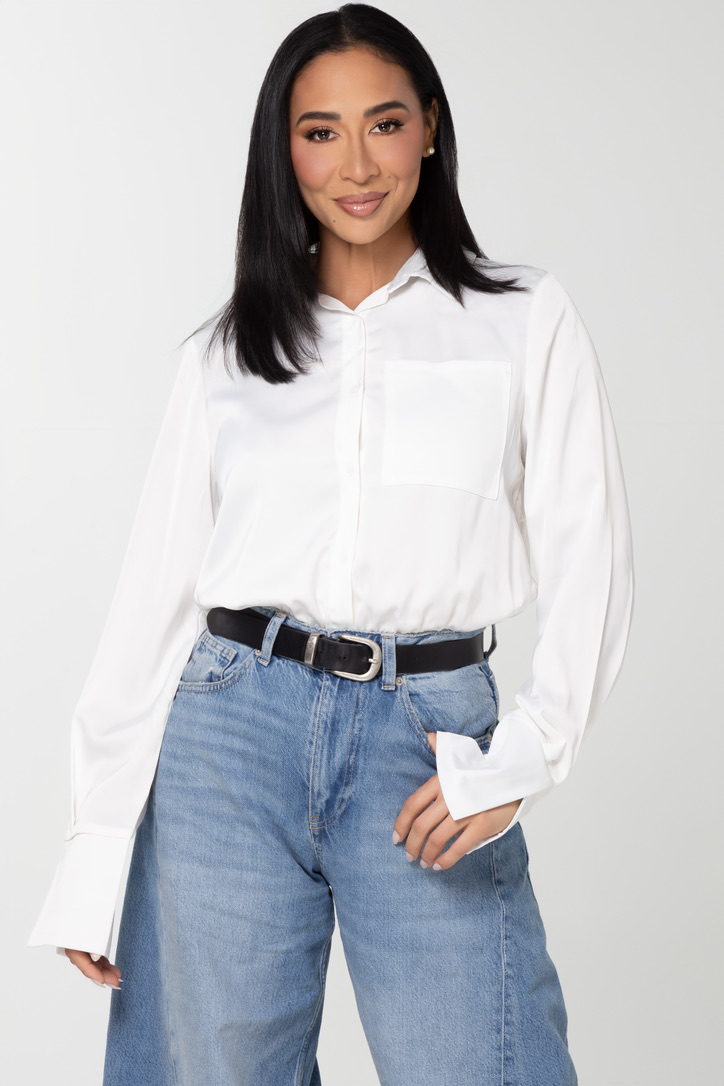 Dr. Sheena Kawamoto in a white shirt and denim, studio portrait